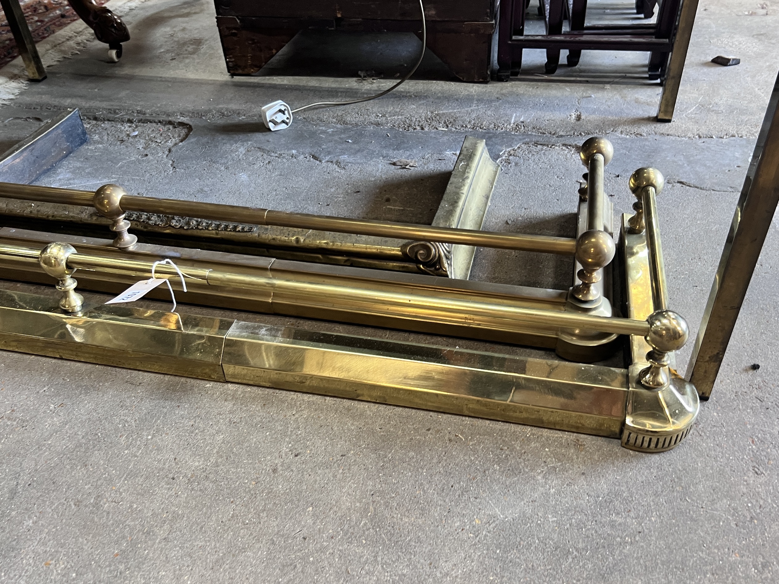 Two Victorian style telescopic brass fenders and a smaller fire curb